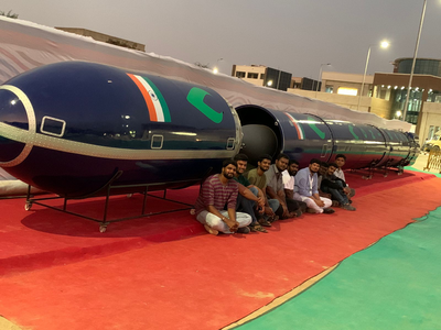 boys sitting beside rocket